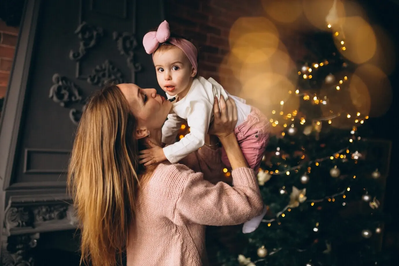 Mother and daughter next to a Christmas tree