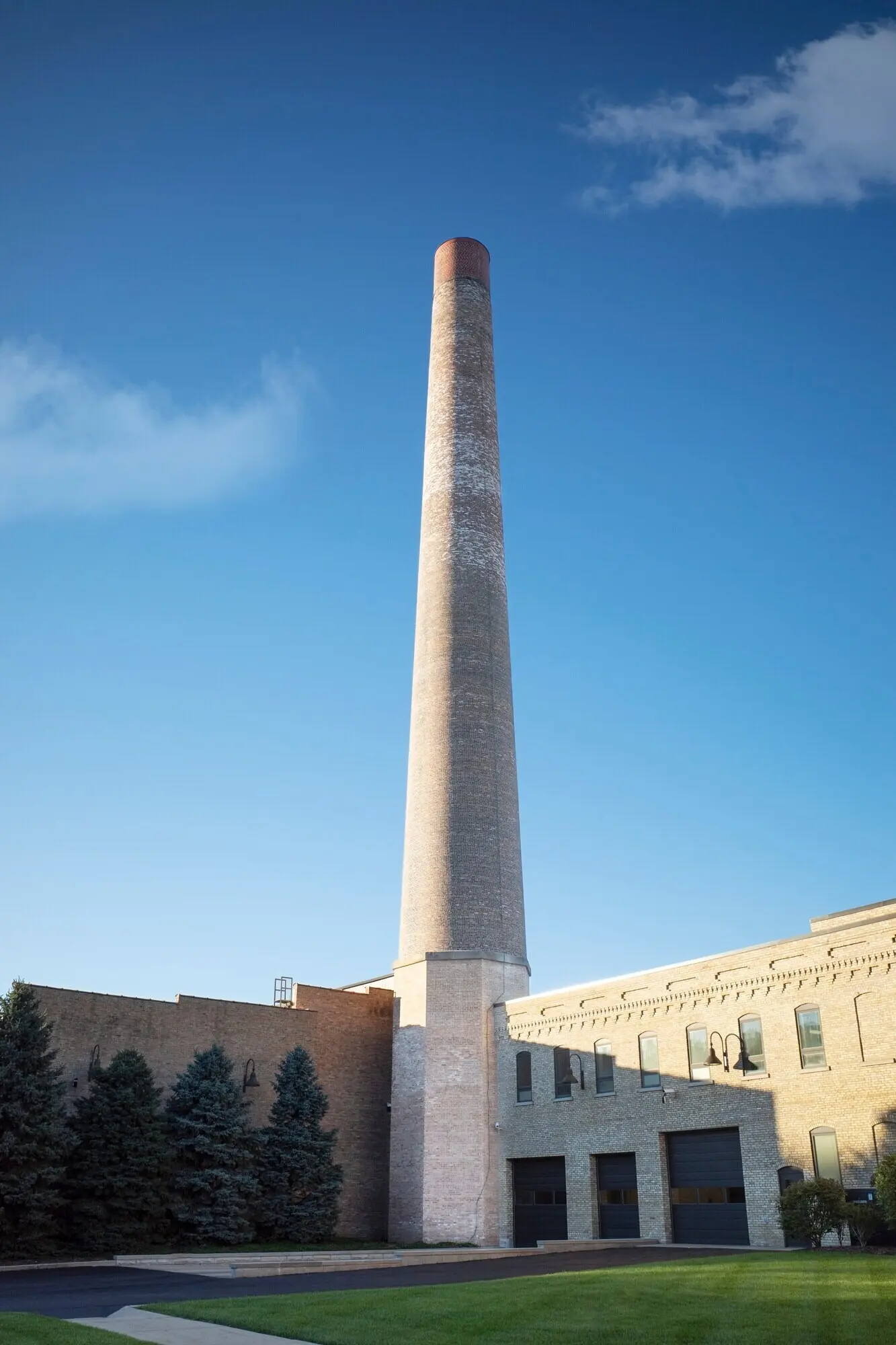A chimney in an urban setting with trees