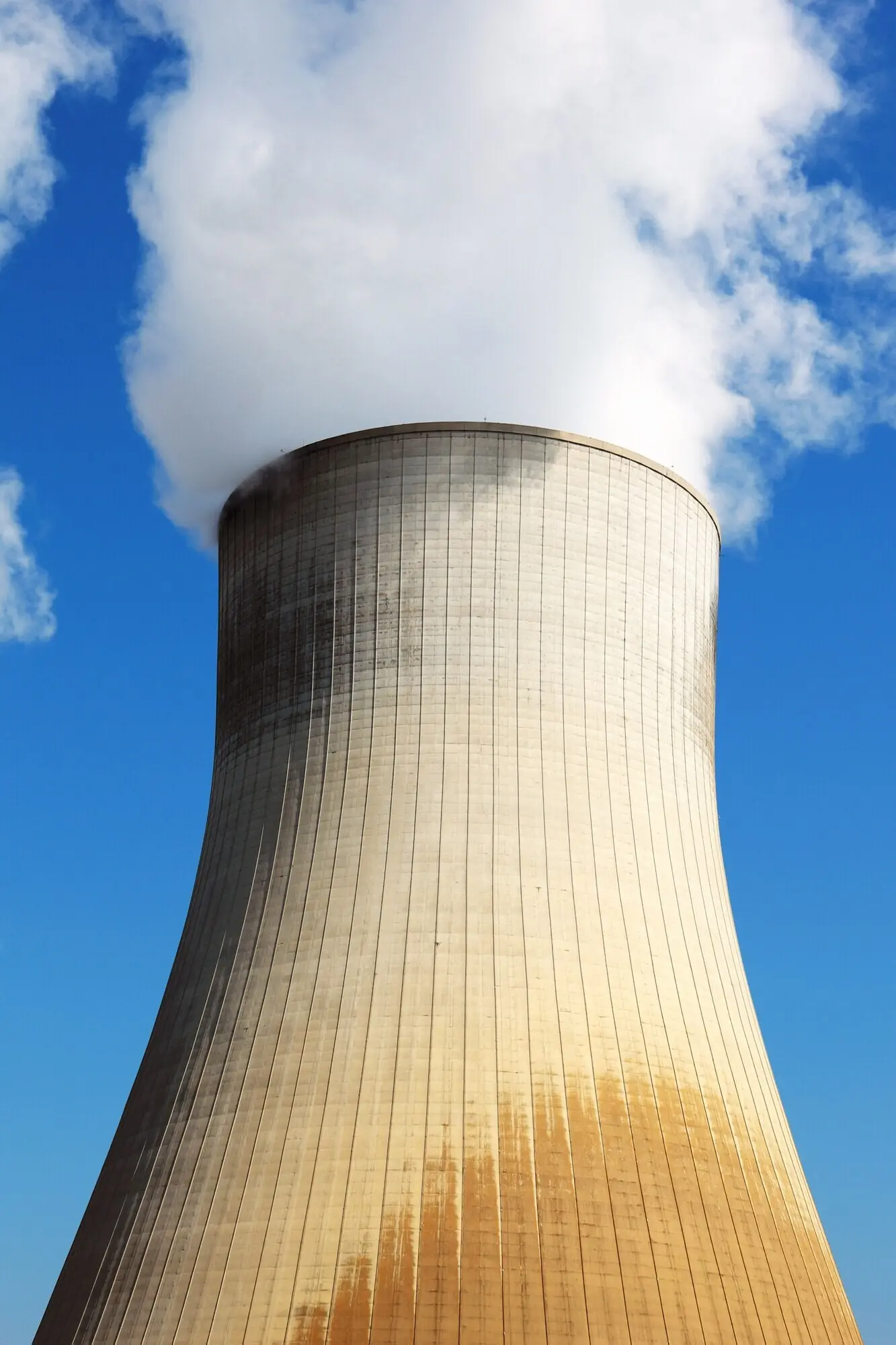 Cooling tower of a nuclear power station against a blue sky